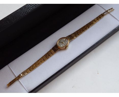 A lady's 9-carat yellow gold dress watch; the oval mother of pearl style dial signed Rotary and with baton markers, 21-jewell