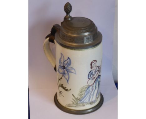 A 19th century German faience pottery stein; hand-decorated with a seated maiden playing an accoustic guitar (later pewter mo