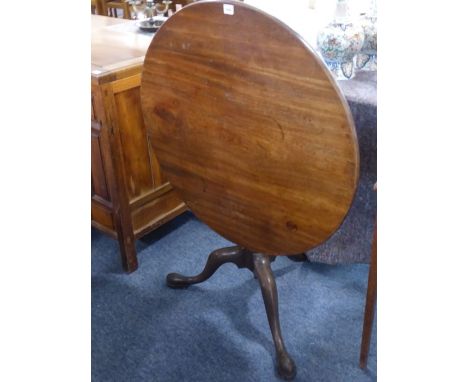 A mid 18th Century circular tilt top mahogany occasional table, the one piece top above gun barrel stem and tripod base with 