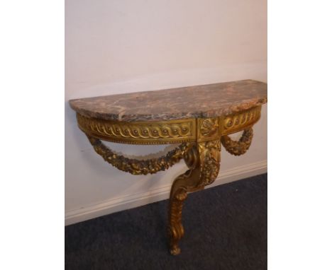 A 19th century (in 18th century style) bow-fronted marble-topped giltwood console table in neo-Classical style, the frieze ce