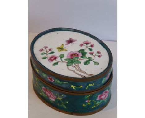 An early 20th century oval Chinese canton enamel box; the cover decorated with butterflies and blossom (9.5cm in diameter)