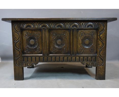 An early 20th carved oak trunk, with floral carved panels, H.62 W.107 D.51cm 