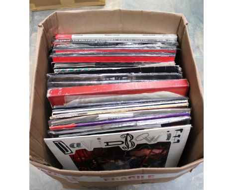 A box of Vinyl LP Records and 12 inch singles mostly from the 1980s including 3 David Bowie 12 inches and LP Day in Day Out. 