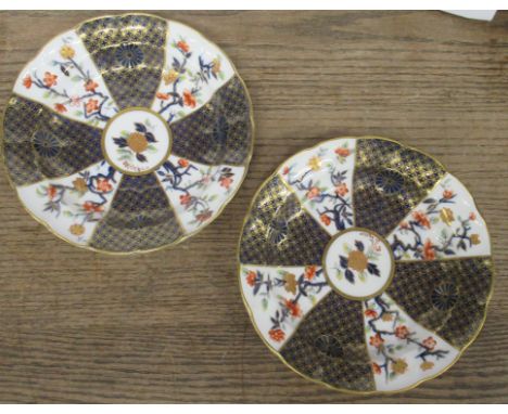 A pair of Royal Worcester saucer dishes, decorated with fans of flowers and blue and gilts in the Imari style, diameter 9.5in