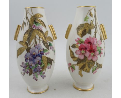A pair of Royal Worcester vases, decorated with flowers and gilt relief leaves, having gilt lug handles, height 9.5ins