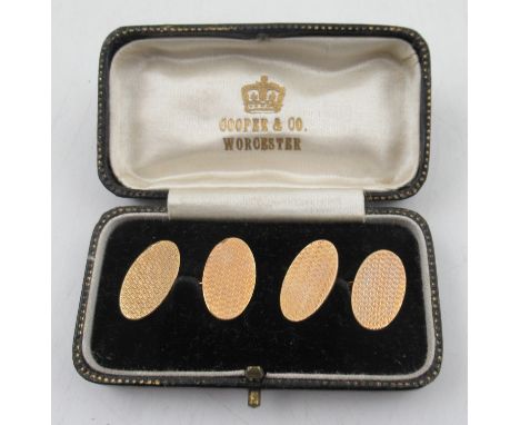 A pair of 9ct gold oval cuff links, with engine turned decoration, weight 6.8g