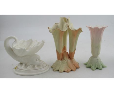 A Royal Worcester blush ivory triform vase, together with a dolphin centre piece and a leaf vase&nbsp;