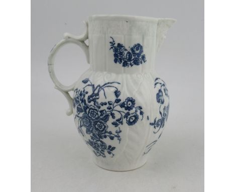 An 18th century cabbage moulded Caughley mask jug, decorated with flowers in underglaze blue, S for Salopian mark, height 7.2