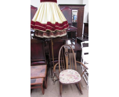 An Ercol rocking chair with swan roundel together with a brass standard lamp and two shades