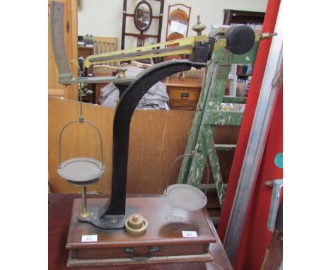 A scales with brass weights and a base drawer