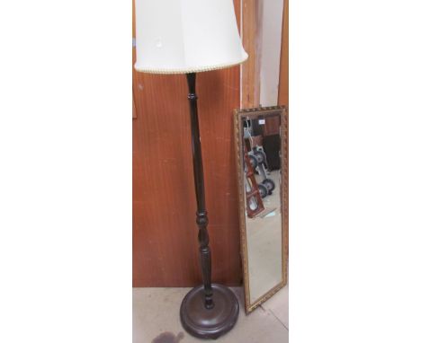 A large gilt wall mirror together with a standard lamp