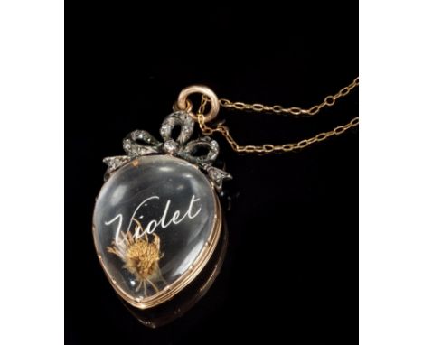 Late Victorian locket with a glazed compartment with intaglio engraved name - 'Violet' and diamond set ribbon surmount, 40mm 