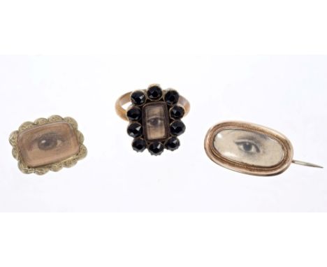 Georgian brooch with glazed compartment containing a watercolour 'lover's eye' portrait, together with a similar brooch and r