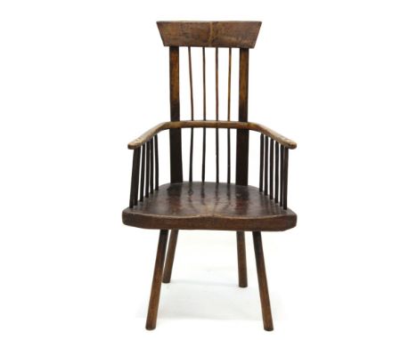 Scarce 19th century Welsh primitive ash and elm comb back chair with high stick back and expansive trapezoidal-shaped solid s