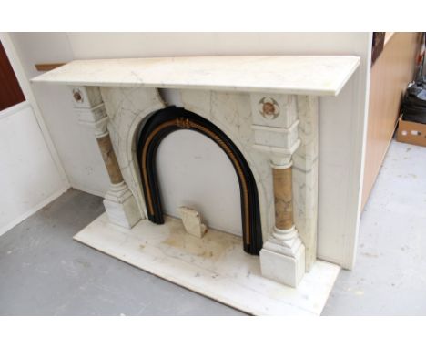 Good Victorian marble fireplace of large size, with expansive mantelpiece on arched frame, with flanking variegated marble co