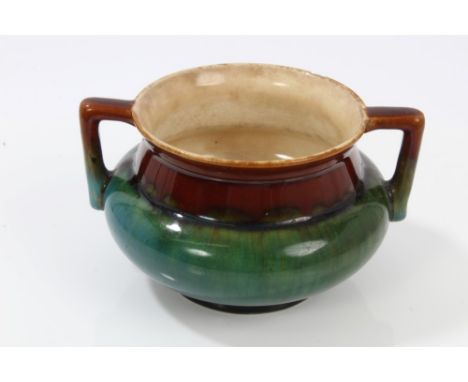 Dr Christopher Dresser designed Linthorpe art pottery pot with twin handles and green, brown and green glaze - impressed mark