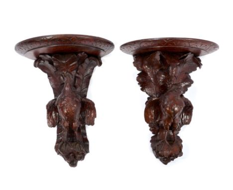 Pair of late 19th / early 20th century Black Forest carved wall brackets in the form of game birds, with semi-circular shelf,