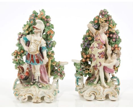 Pair late 18th century Derby porcelain figures of a warrior in armour with cockerel and floral bocage and a lady with cherub 