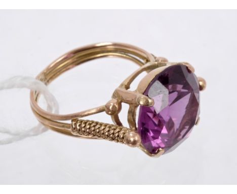 Gold and faux alexandrite single stone dress ring in four-claw setting with gold wirework shoulders. Ring size M