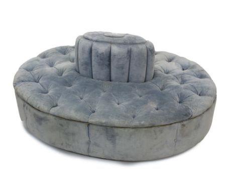 Victorian-style blue button-upholstered conversation seat of oval form, raised on castors