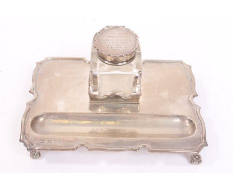 1920s silver ink stand of shaped rectangular form, with raised border, pen tray and silver mounted cut glass inkwell with hin