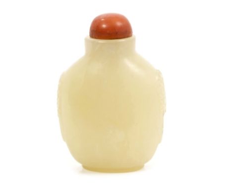 Chinese Qing carved green jade snuff bottle with stained ivory stopper and carved ring side handles, 6.3cm overall CONDITION 