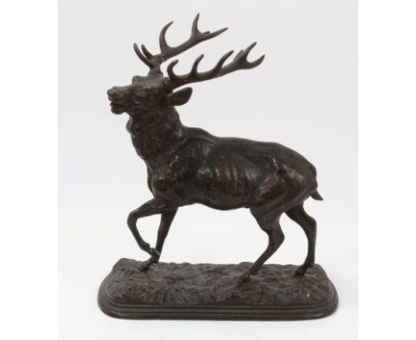 Late 19th century Continental bronze figure of a baying stag, raised on naturalistic oval plinth base, 18cm wide