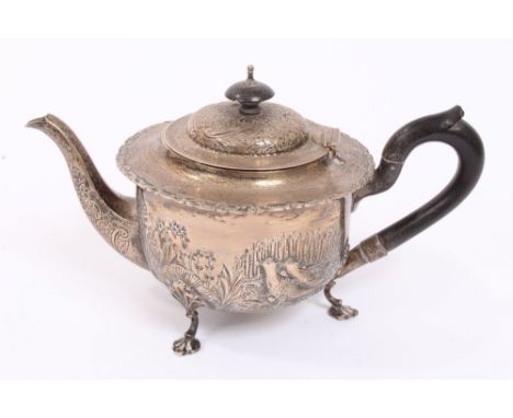 Late Victorian silver teapot of circular form, with flared scroll border, embossed decoration of rabbits and birds against a 