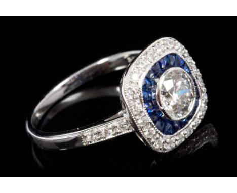 Diamond and sapphire ring, the central brilliant cut diamond estimated to weigh approximately 0.65 carats, surrounded by cali