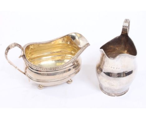 George III silver cream jug of helmet form, with vacant cartouche, rim and reeded loop handle (London 1801), maker's mark rub