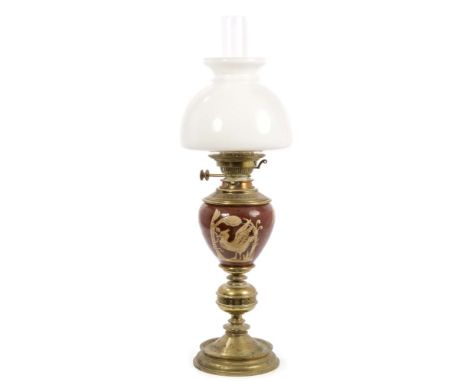 Good 19th century pottery and brass mounted oil lamp with shaped milk glass shade, the onion-form reservoir slip decorated in