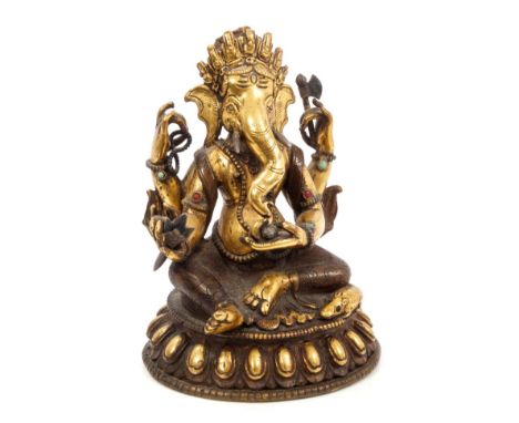 Antique Tibetan gilt bronze figure of Ganesh - finely modelled and applied with a rat at his feet, in typical pose, on lobed 
