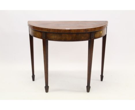 George III mahogany and tulipwood crossbanded demi-lune card table, the fold-over top enclosing baize-lined interior, on pate