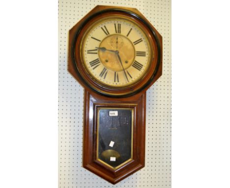 An American wall mounted clock octagonal frame enclosing circular face, Roman numerals, secondary aperture dial twin winding 