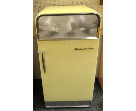 An original Frigidaire refrigerator/ freezer, cream ground, pink interior, stylish fish tail handle, decorative mirror panel 