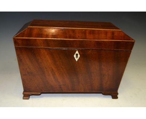 A George III mahogany sarcophagus tea caddy, hinged cover enclosing a pair of lidded compartments, brass lion mask handles, o