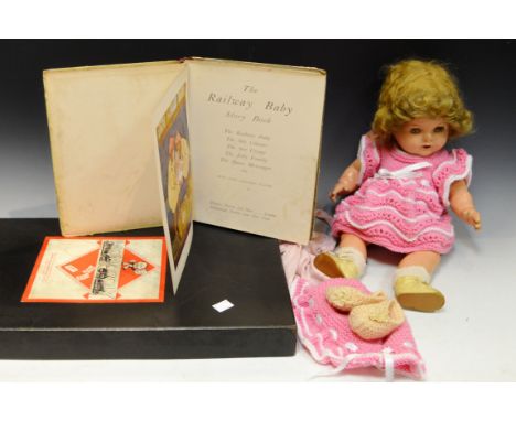 Toys - a Reliable composite doll, stamped Made in Canada; a Monopoly board; The Railway Baby Book