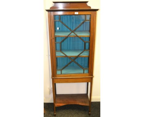 An Edwardian mahogany and satinwood crossbanded display cabinet, astragal glazed door, above incurved shelf c.1910