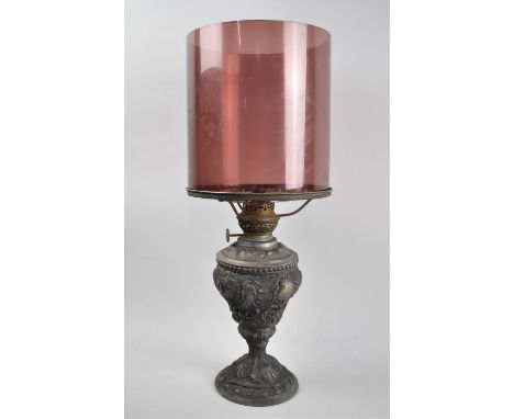 A Late Victorian Cast Metal Oil Lamp with Aubergine Glass Storm Shade, Moulded Decoration to Base, 48cms High Overall 