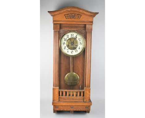 An Edwardian Oak Framed Eight Day Wall Clock, the Glazed Hinged Front Opening to Enamel Face with Arabic Numerals and Central