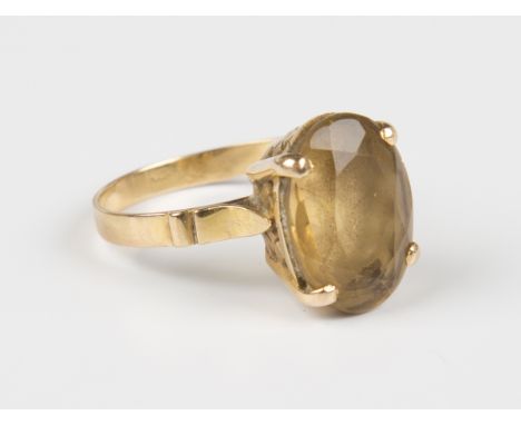 A gold ring, claw set with an oval cut smoky quartz, unmarked, weight 4.8g, ring size approx R.Buyer’s Premium 29.4% (includi