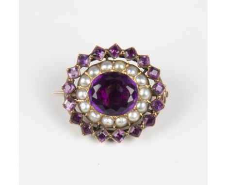 A late 19th century gold, amethyst and seed pearl oval brooch, mounted with the principal foil backed oval cut amethyst withi