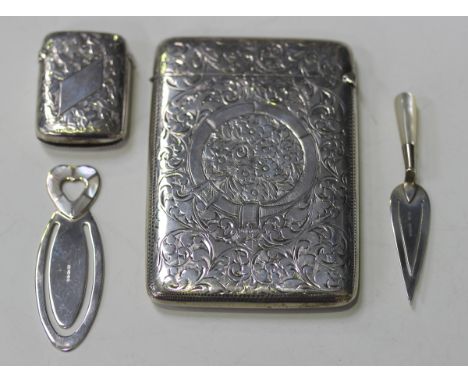 An Edwardian silver rectangular card case with foliate scroll engraved decoration framing a vacant cartouche, Birmingham 1901