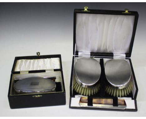 A pair of Elizabeth II silver backed hairbrushes and matching comb, each with engine turned decoration, London 1969, cased, t