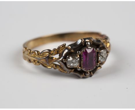 A Victorian gold and silver set, ruby and diamond three stone ring, circa 1850, mounted with the cushion cut ruby between two