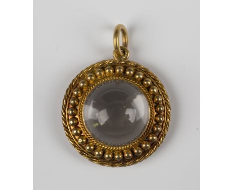 A Victorian gold and cabochon rock crystal circular pendant, circa 1870, with a beaded and ropetwist surround, unmarked, weig