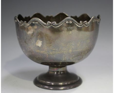 A George V silver footed bowl with cast scroll rim, raised on a circular flared stepped foot, Birmingham 1919 by William Henr