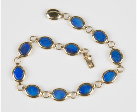 A 14ct gold and blue opal doublet oval link bracelet on an oval gold clasp, weight 7.2g, length 18.5cm, with a case.Buyer’s P