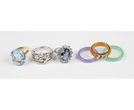 A 9ct gold and diamond ring with three interchangeable coloured bands, a gold and pale blue paste solitaire ring and two silv