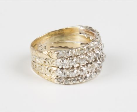 A gold and diamond four row ring, claw set with circular cut diamonds with engraved decoration, weight 4.3g, ring size approx